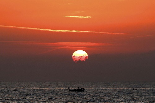 Rybár počas západu Slnka