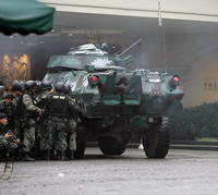 Vládne jednotky prerazili vchod do hotela Peninsula vo finančnej štvrti Makati obrneným vozidlom.