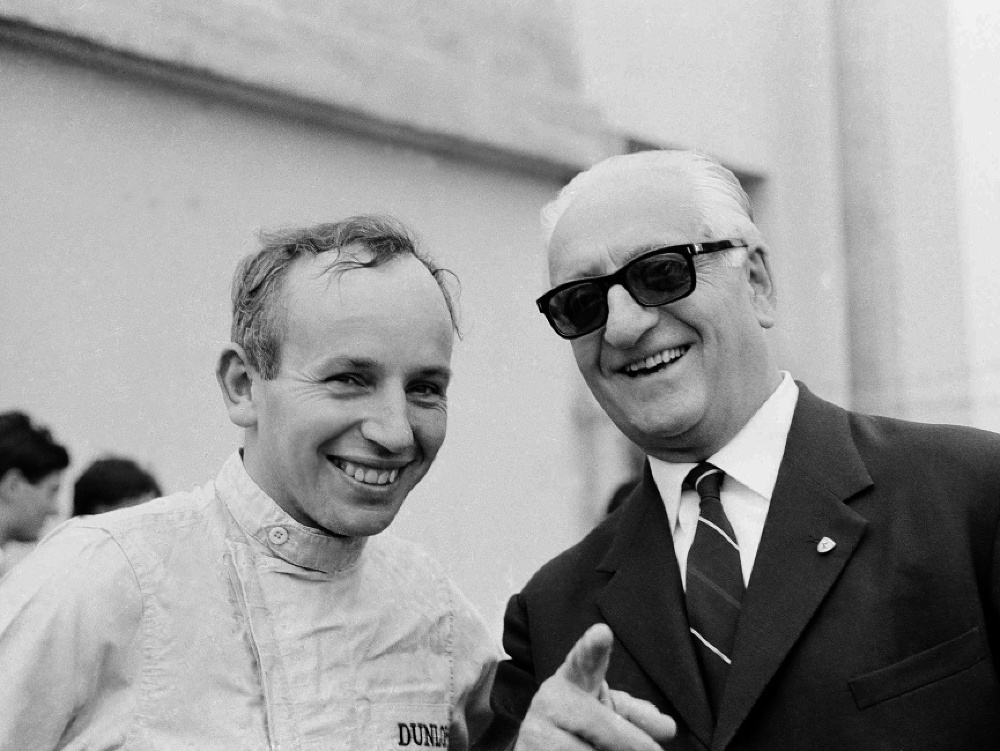 Na archívnej snímke 4. septembra 1964 jazdec F1 John Surtees (vľavo) a Enzo Ferrari na okruhu v Monze.