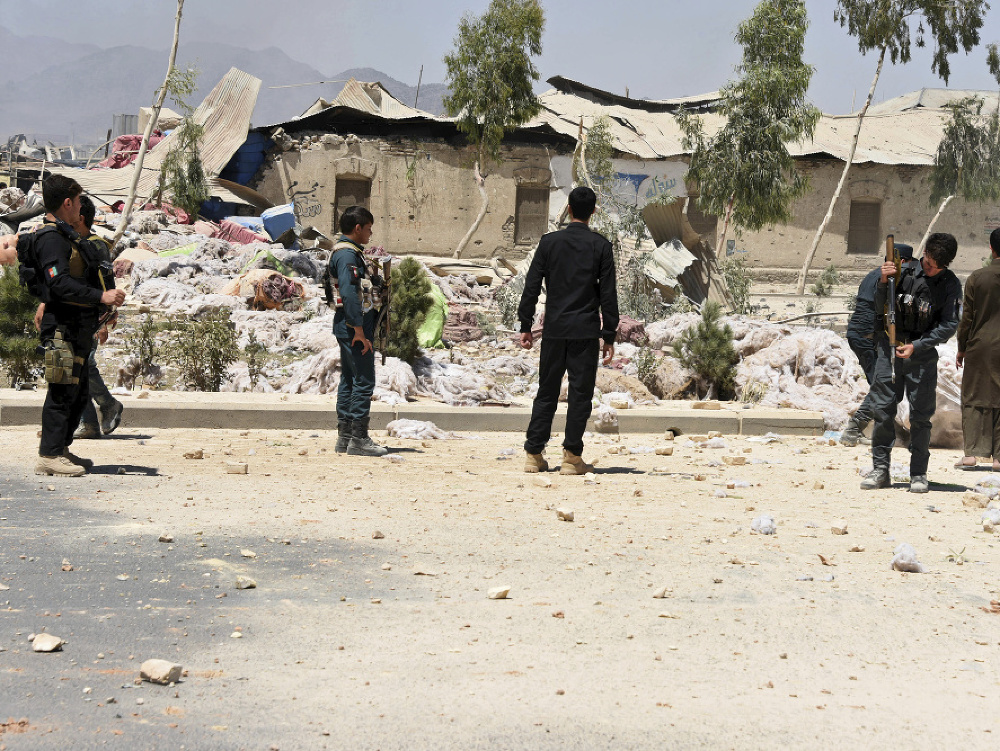 Bezpečnostní pracovníci prehľadávajú miesto výbuchu v afganskom Kandaháre.