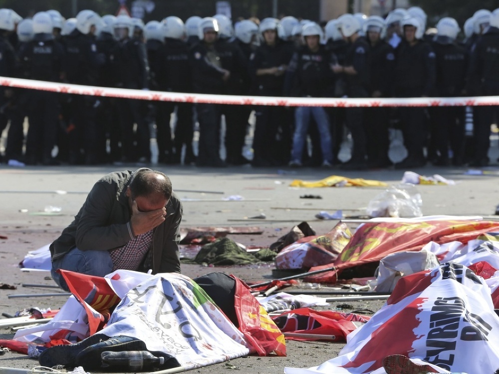 Na archívnej snímke z 10. októbra 2015 muž narieka nad telom obete na mieste bombového výbuchu počas mierovej demonštrácie v Ankare.