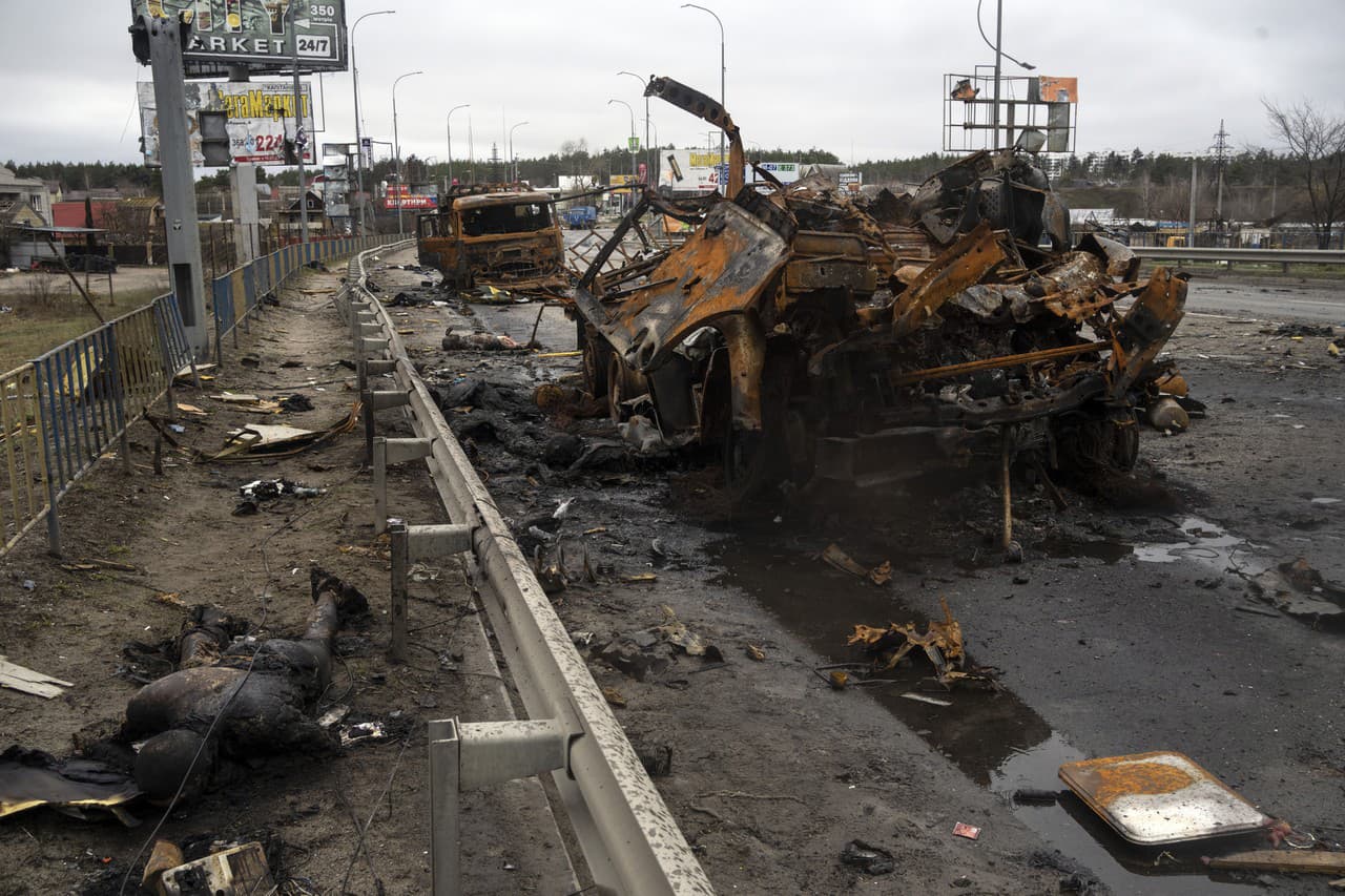 Mŕtvi ruskí vojaci ležia na zemi vedľa zvyškov vozidiel v Buči na okraji Kyjeva.