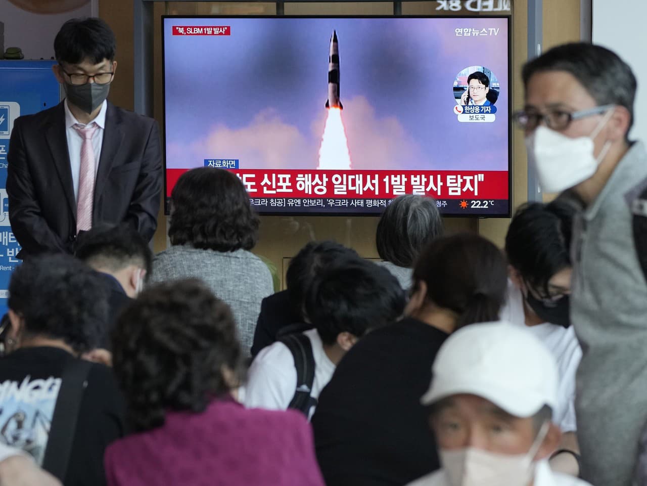 Cestujúci sledujú televízne správy o odpálení strely zo strany KĽDR na železničnej stanici v Soule.