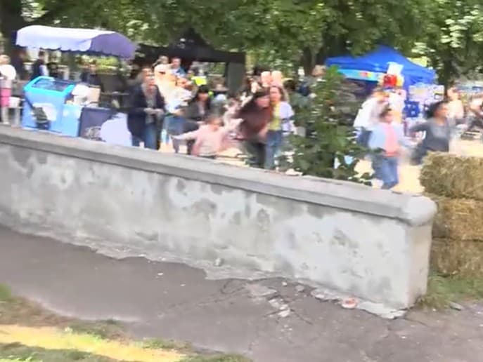 Ľudia v panike utekajú zo slávností v Černigove po tom, ako sa vzduchom ozval strašný výbuch. 