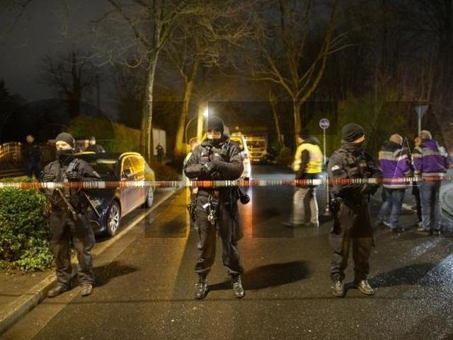 Policajti stoja za páskou, neďaleko nehody vlaku v Nemecku.