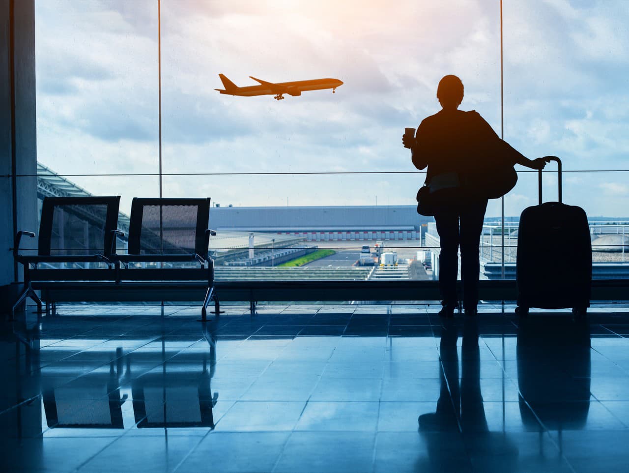 travel by plane, woman passenger waiting in airport, silhouette of passenger in airport watching aircraft taking off