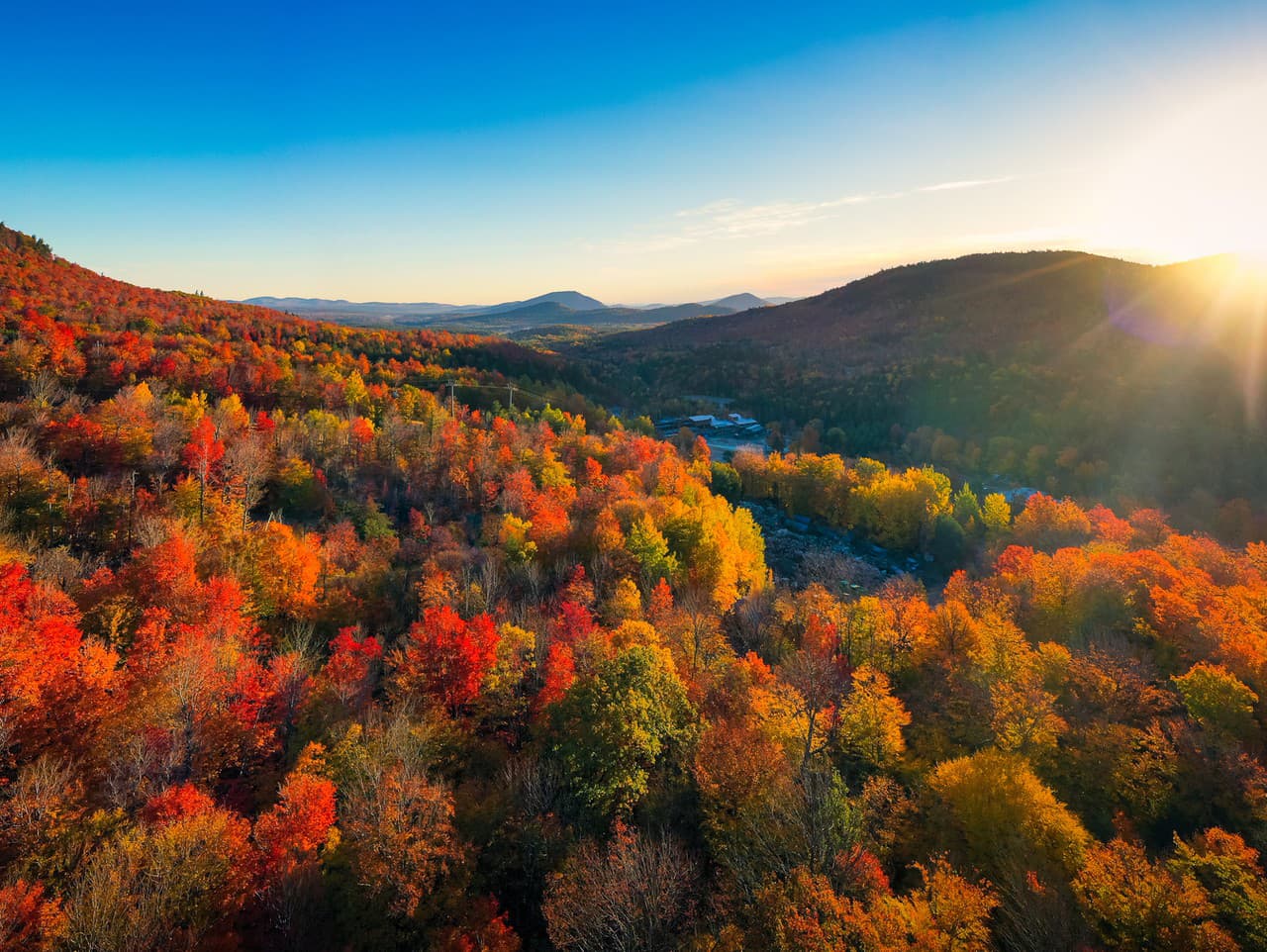 Aerial view of Mountain Forests with Brilliant Fall Colors in Autumn at Sunrise, Adirondacks, New York, New England