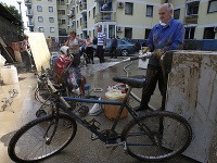 Ľudia na Balkáne upratujú po ničivých povodniach.