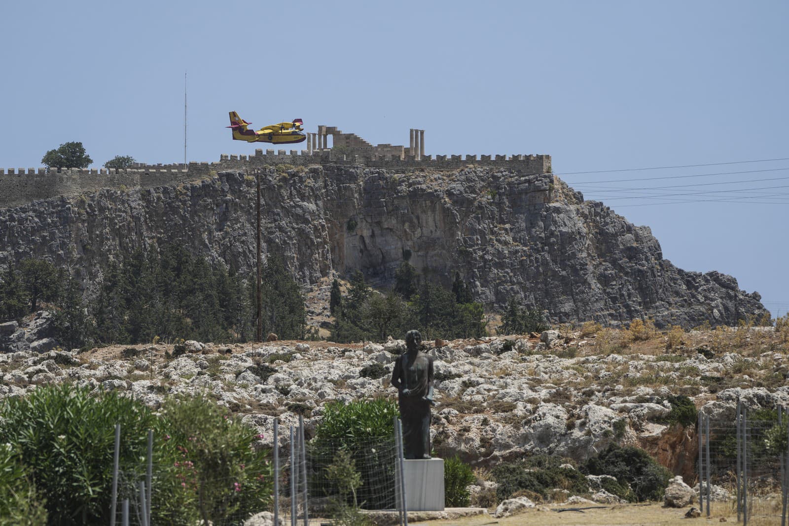 Lietadlo Canadair letí za archeologickým náleziskom Lindos na ostrove Rhodos v Egejskom mori na juhovýchode Grécka