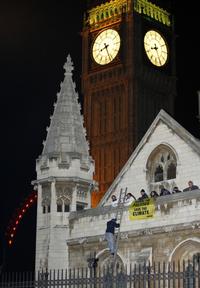Aktivisti Greenpeace na streche britského parlamentu.