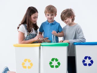 Kids segregating trash into different coloured bins