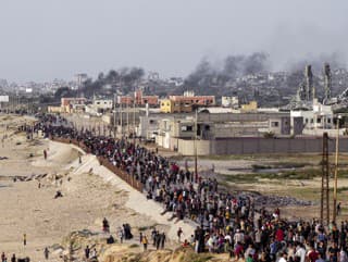 Palestínčania čakajú na nákladné autá s humanitárnou pomocou v centre pásma Gazy v nedeľu 19. mája 2024.