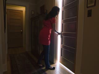 Woman opening bedroom door
