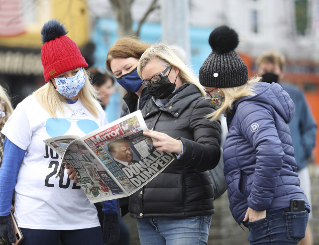 Obyvatelia si čítajú vydanie miestnych novín v severoírskom meste Ballina, ktoré je domovom predkov Joea Bidena.