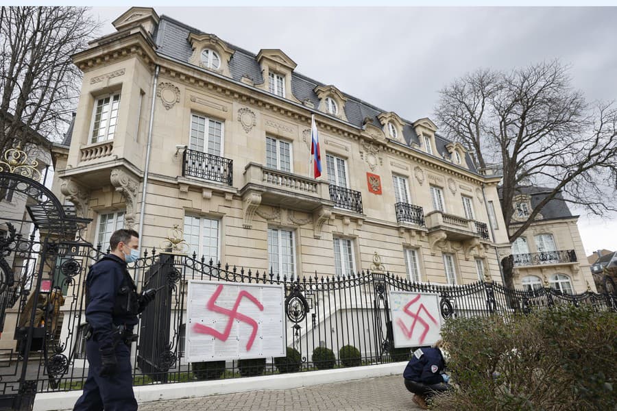 Francúzski policajti pred ruským konzulátom, kde neznámy páchateľ nasprejoval na plot hákové kríže