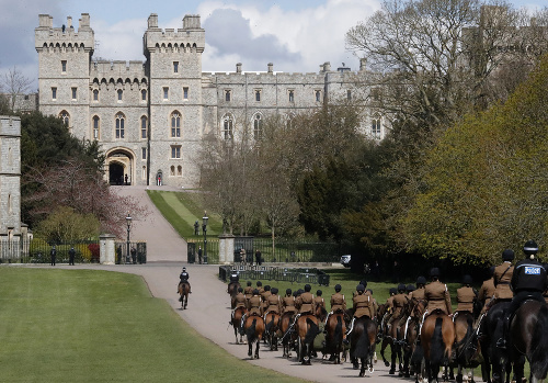 Členovia Kráľovského konského delostrelectva prichádzajú počas skúšky poslednej rozlúčky princa Philipa po chodníku Long Walk k Windsorskému zámku vo Windsore.