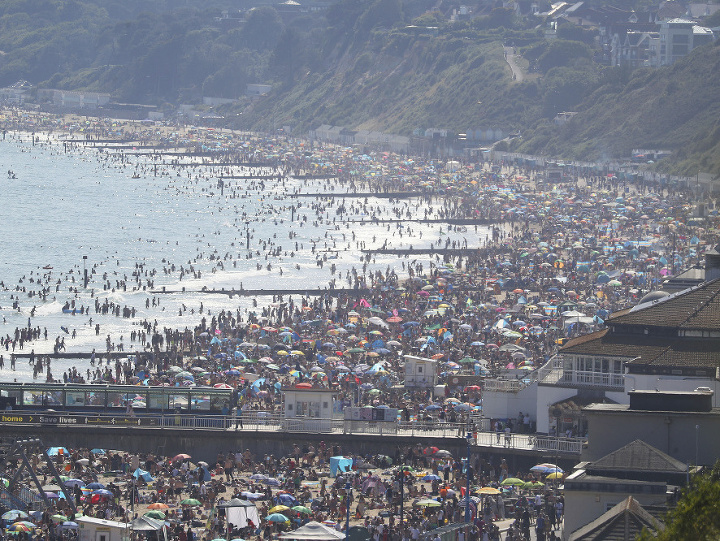  Ľudia sa opaľujú a kúpu na pláži počas najteplejšieho dňa roka po uvoľnení sociálnych opatrení na zabránenie šíreniu nového koronavírusu v anglickom Bournemouthe 24. júna 2020. Anglicko postihla vlna horúčav. FOTO TASR/AP 

People are seen on the beach o