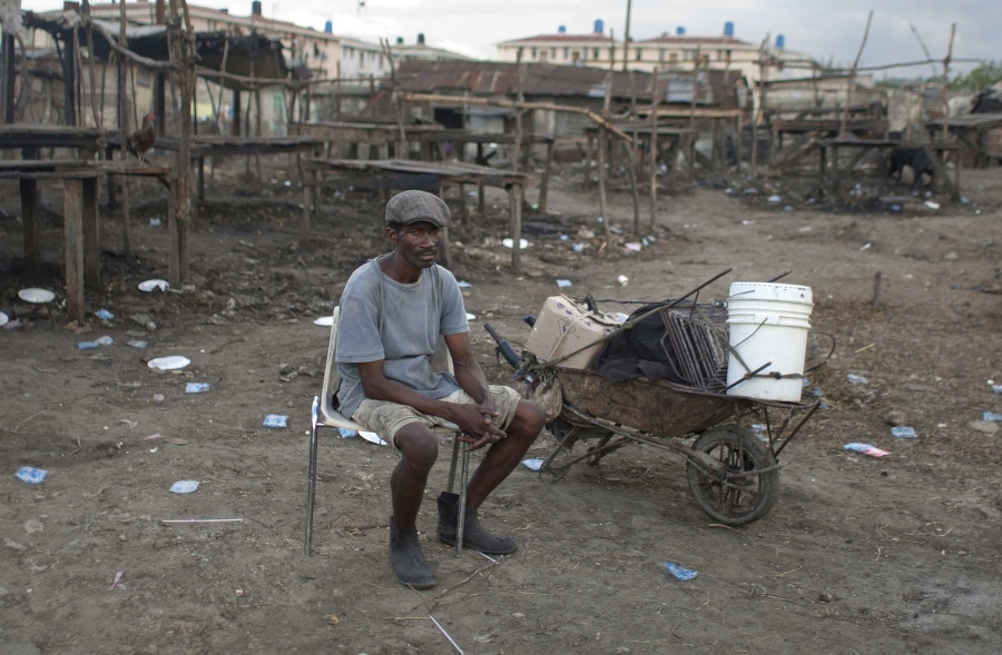 Robotník na trhu na ulici v Port-au-Prince.