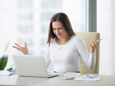 žena sa hnevá v práci na svoj počítač