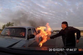 Svedkovia a horiace auto