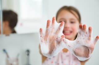 Little girl washing hands